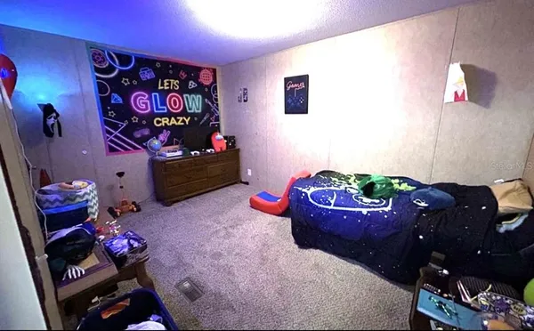 a bedroom with a bed and a dresser