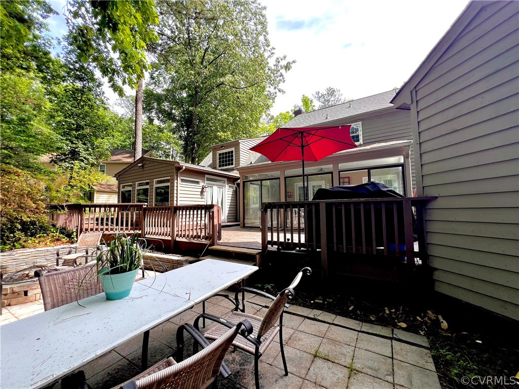 13604 Winterberry Ridge Midlothian, VA 23112 - Photo 25 of 50 a view of a patio with table and chairs barbeque potted plants and large tree