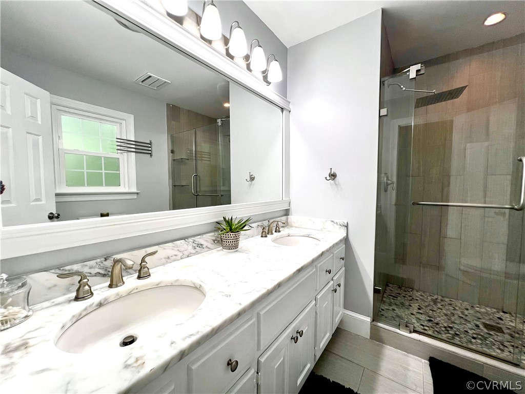 13604 Winterberry Ridge Midlothian, VA 23112 - Photo 40 of 50 a bathroom with a sink double vanity and a shower