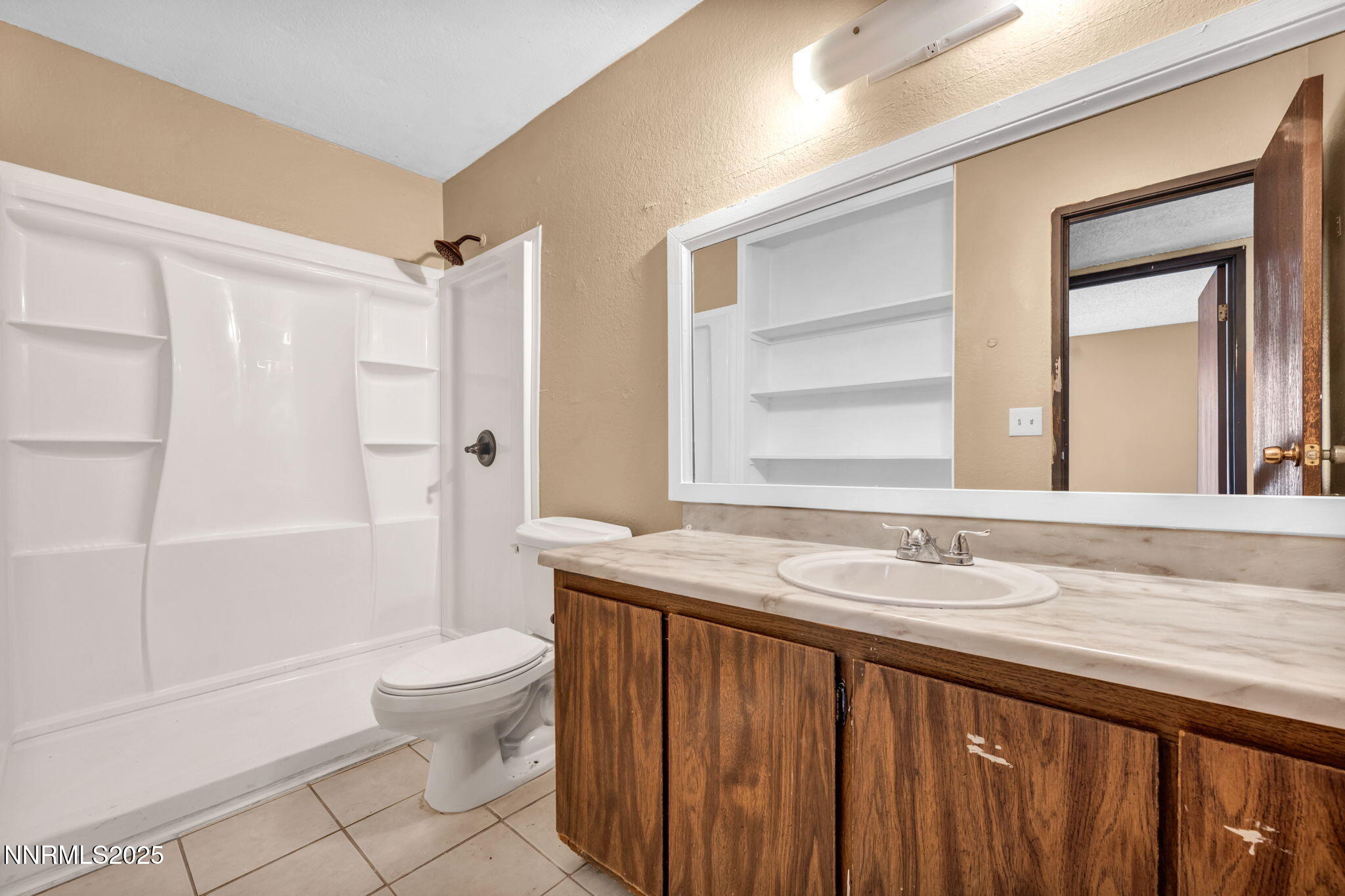 4600 Neil Road, Unit 35 Reno, NV 89502 - Photo 14 of 23 a bathroom with a granite countertop sink toilet and shower