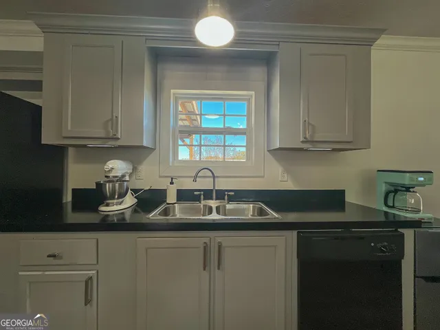a kitchen with a sink and cabinets