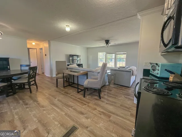a living room with furniture and a wooden floor