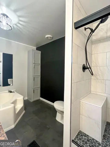 a bathroom with a glass shower door