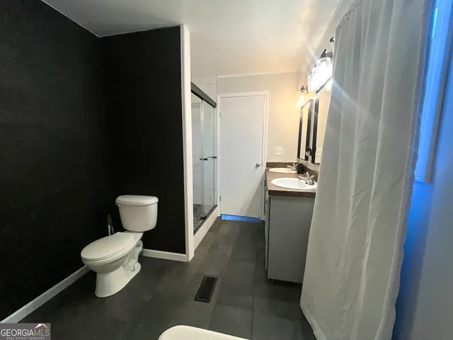 a bathroom with a double vanity sink and a mirror