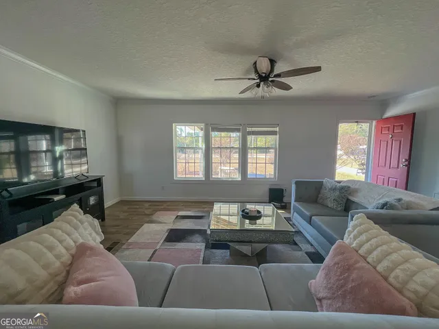 a living room with furniture and a flat screen tv