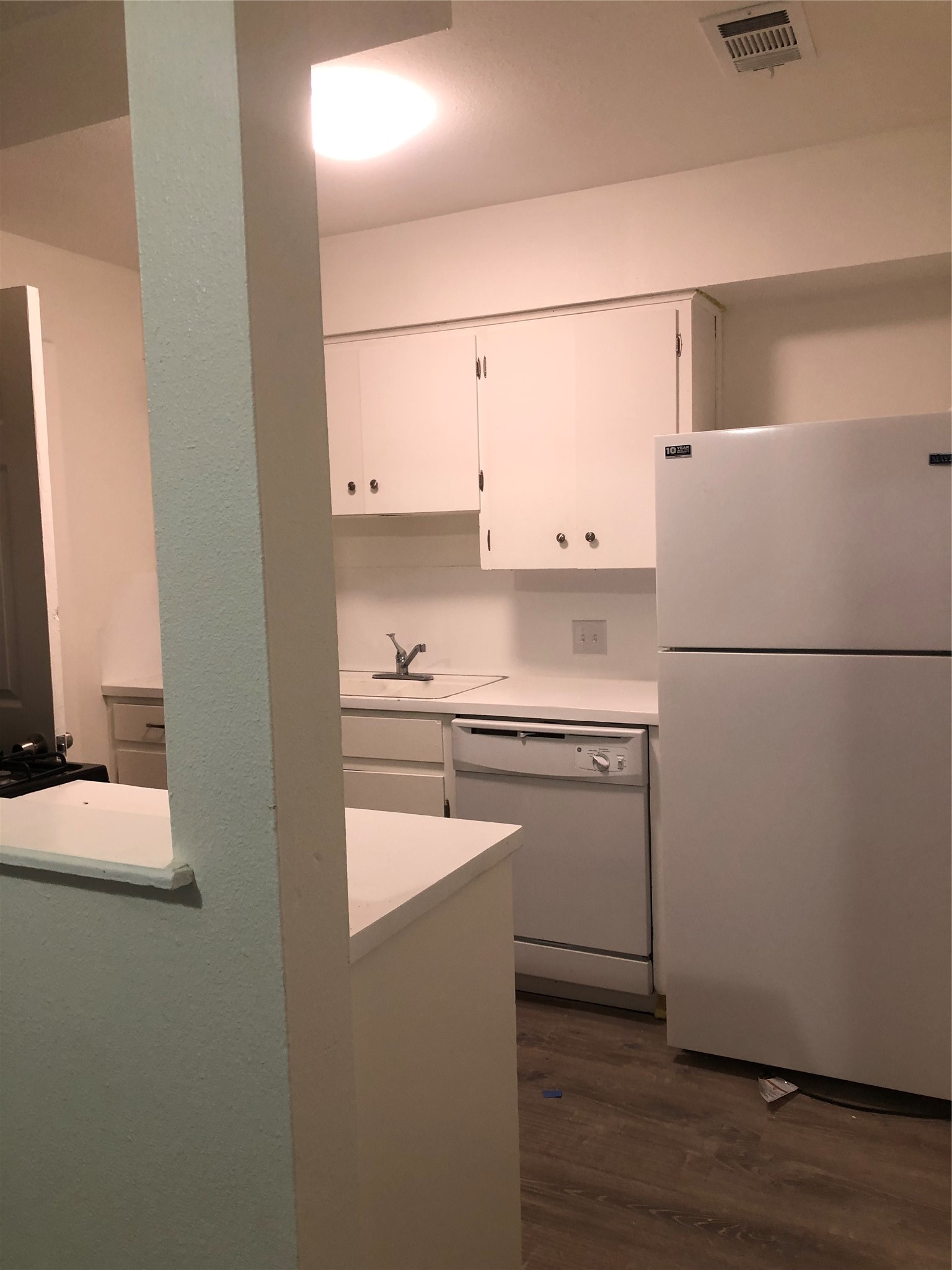 6502 South 1st Street, Unit 102 Austin, TX 78745 - Photo 10 of 26 a kitchen with cabinets and a refrigerator