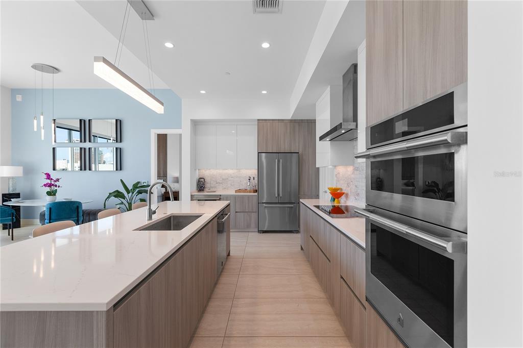 301 Quay Commons, Unit 509 Sarasota, FL 34236 - Photo 12 of 45 a large kitchen with stainless steel appliances