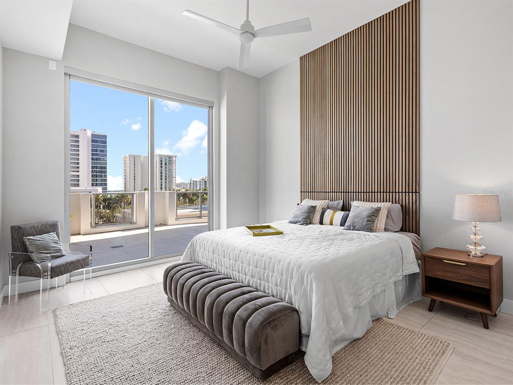 301 Quay Commons, Unit 509 Sarasota, FL 34236 - Photo 13 of 45 a bedroom with a large bed and a large window