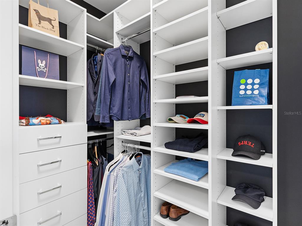301 Quay Commons, Unit 509 Sarasota, FL 34236 - Photo 16 of 45 a view of walk in closet with clothes and shoes