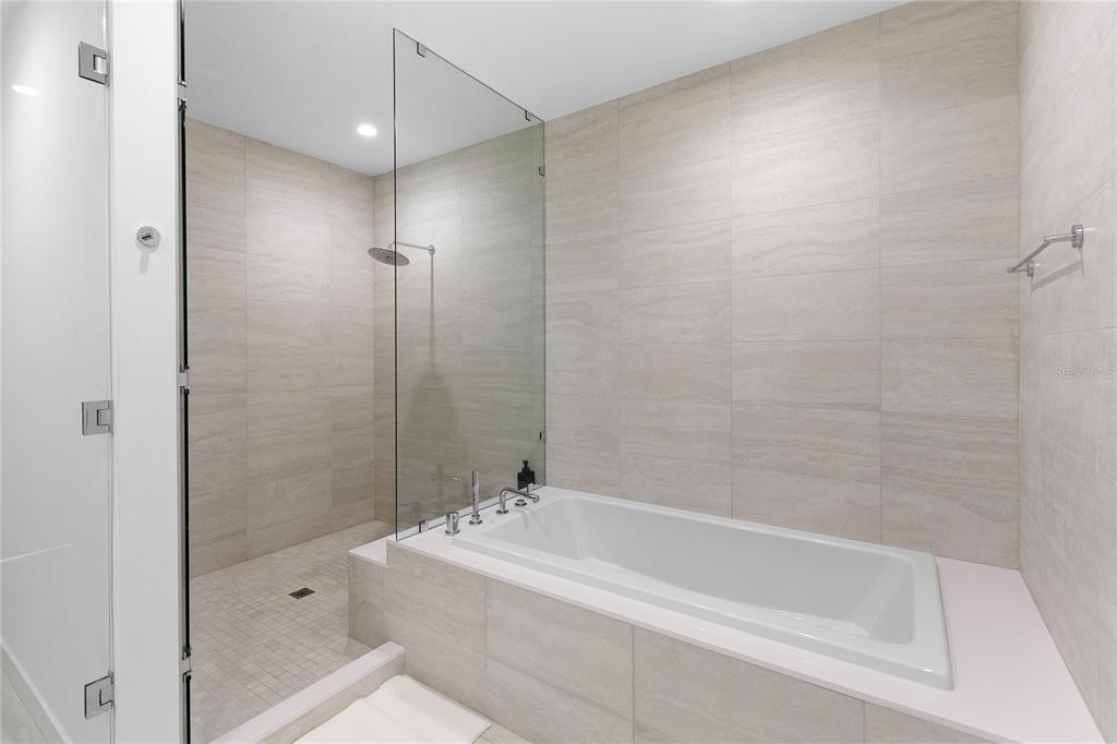 301 Quay Commons, Unit 509 Sarasota, FL 34236 - Photo 18 of 45 a bathroom with a bathtub and a shower