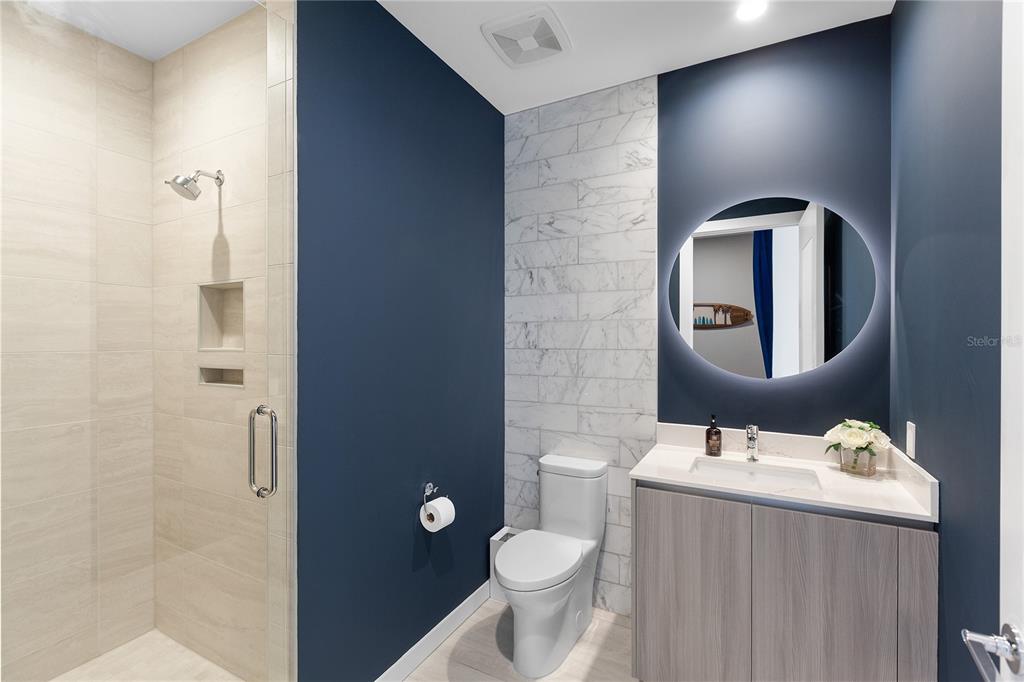 301 Quay Commons, Unit 509 Sarasota, FL 34236 - Photo 20 of 45 a bathroom with a toilet sink and mirror