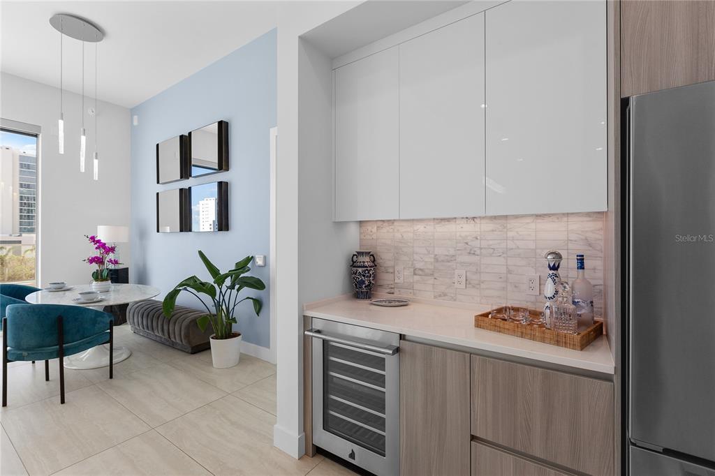 301 Quay Commons, Unit 509 Sarasota, FL 34236 - Photo 6 of 45 a kitchen with a table and chairs in it