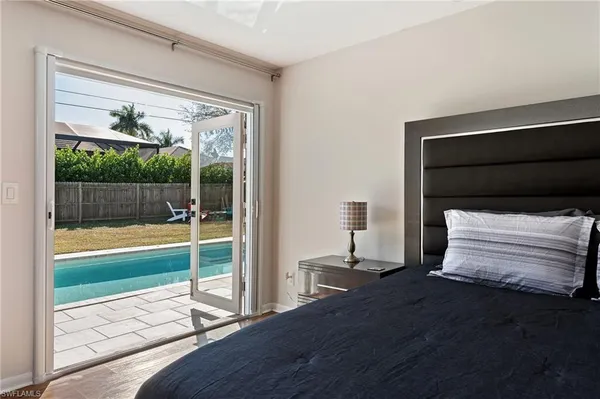 a bedroom with a bed and balcony view