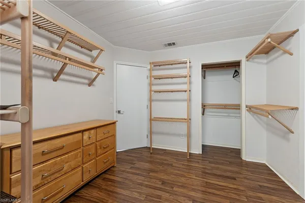 a view of walk in closet with empty racks