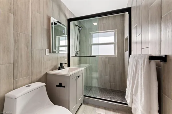 a bathroom with a sink toilet and shower