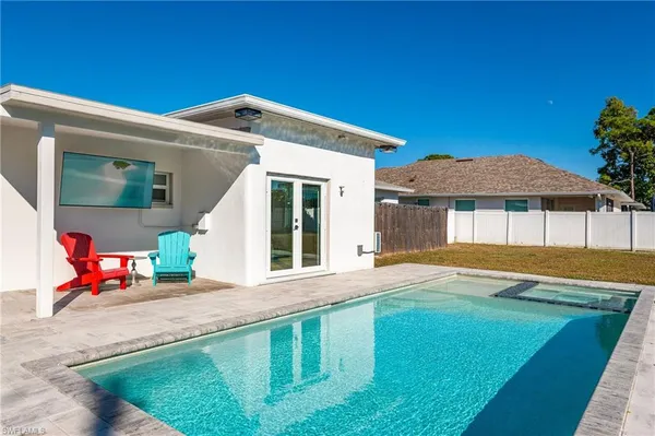 a view of a house with pool and a yard