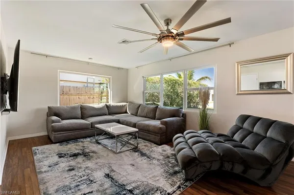 a living room with furniture and a large window
