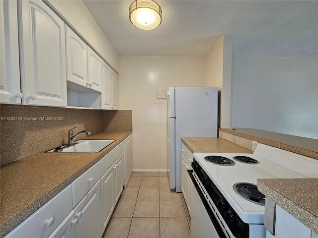 a kitchen that has a sink and a stove
