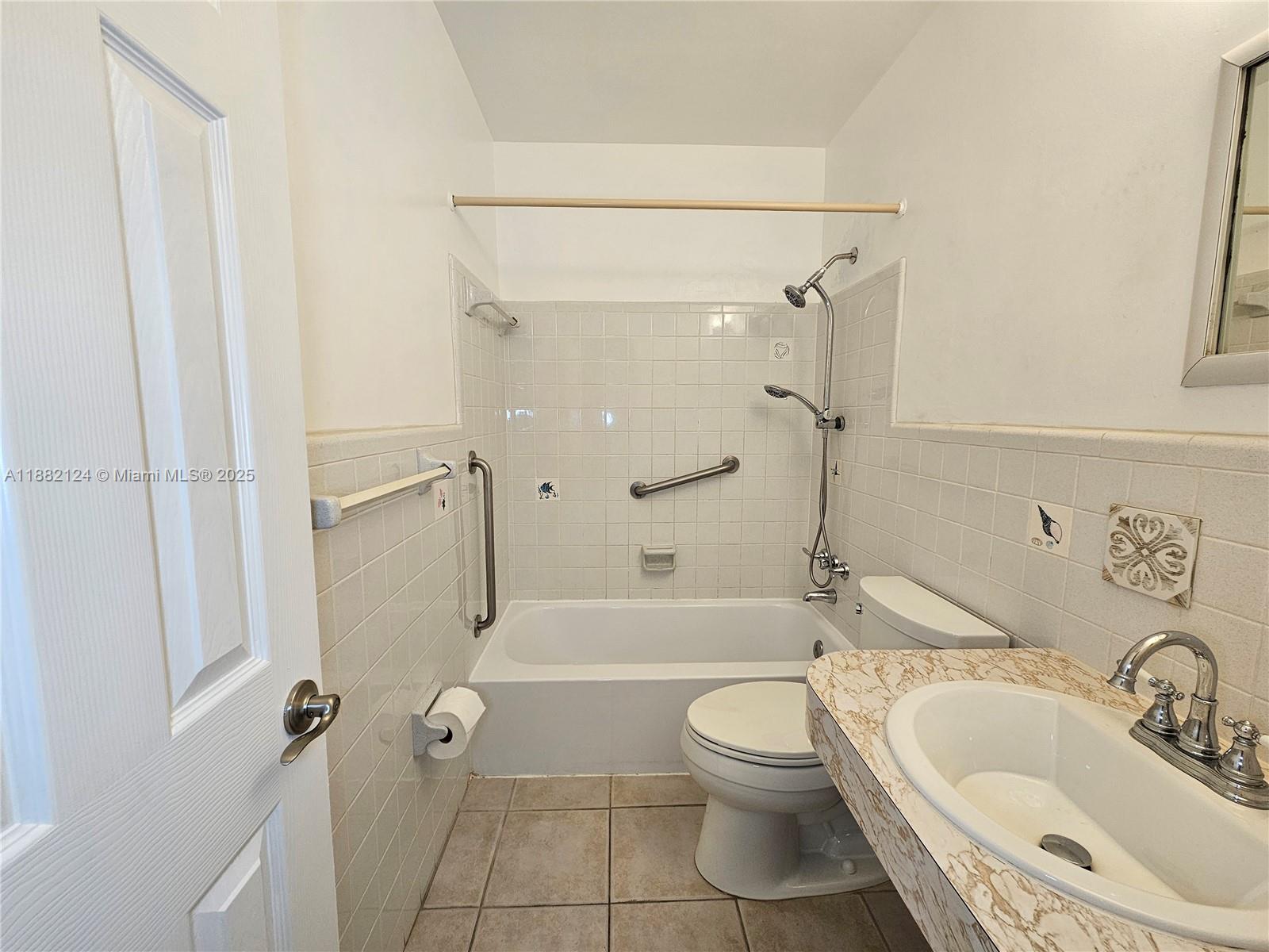3217 Northeast 7th Place, Unit 2 Pompano Beach, FL 33062 - Photo 14 of 20 a bathroom with a sink toilet and shower