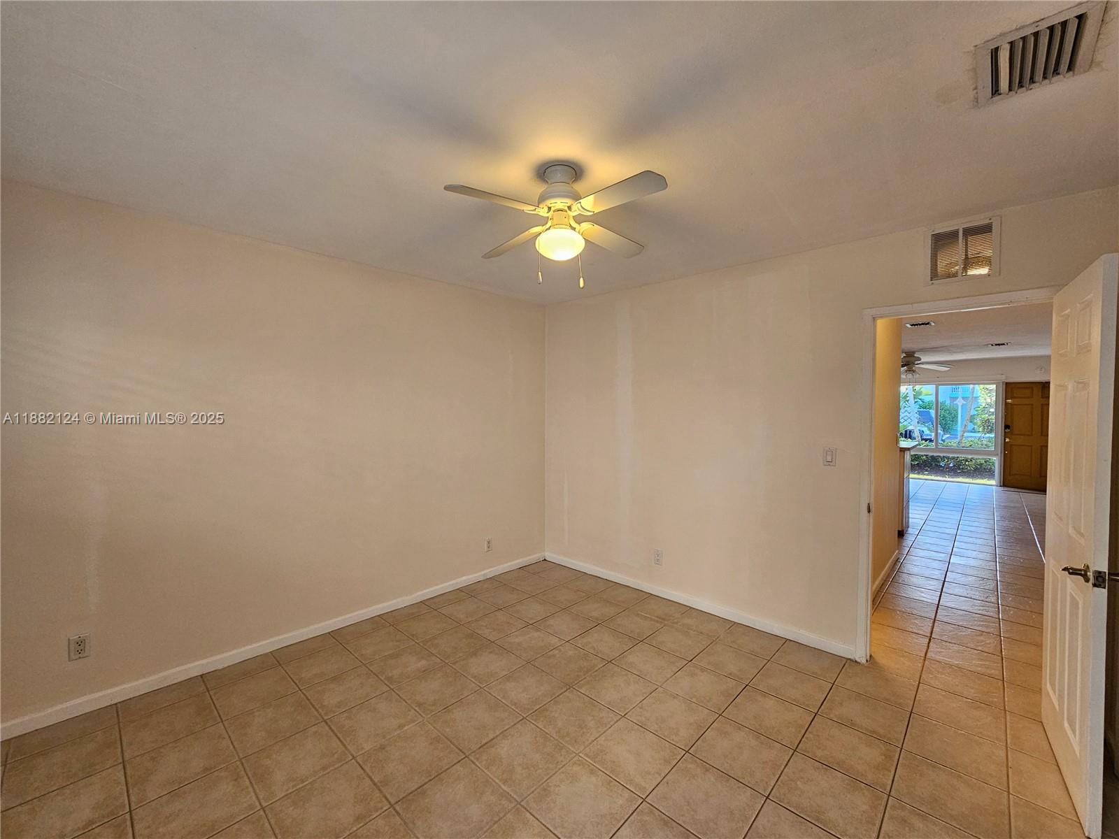 3217 Northeast 7th Place, Unit 2 Pompano Beach, FL 33062 - Photo 15 of 20 an empty room and chandelier fan