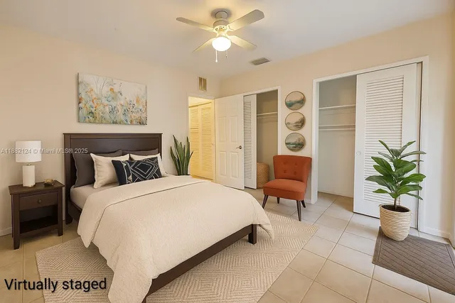 a bedroom with a large bed and potted plant