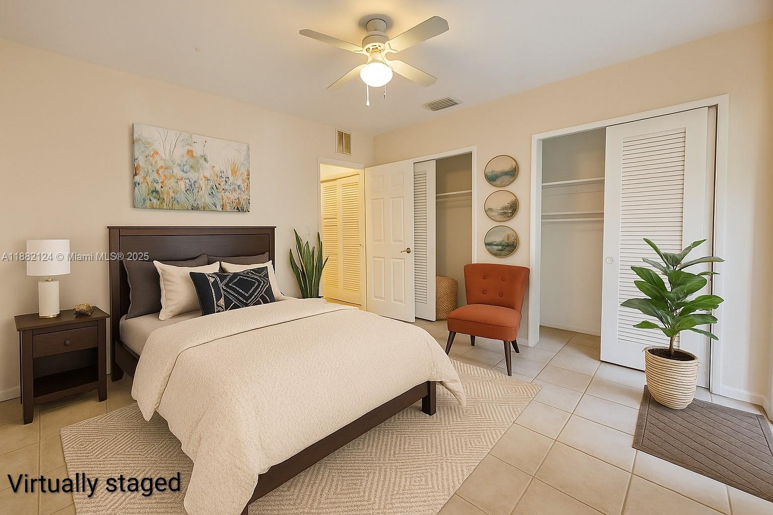3217 Northeast 7th Place, Unit 2 Pompano Beach, FL 33062 - Photo 5 of 20 a bedroom with a large bed and potted plant