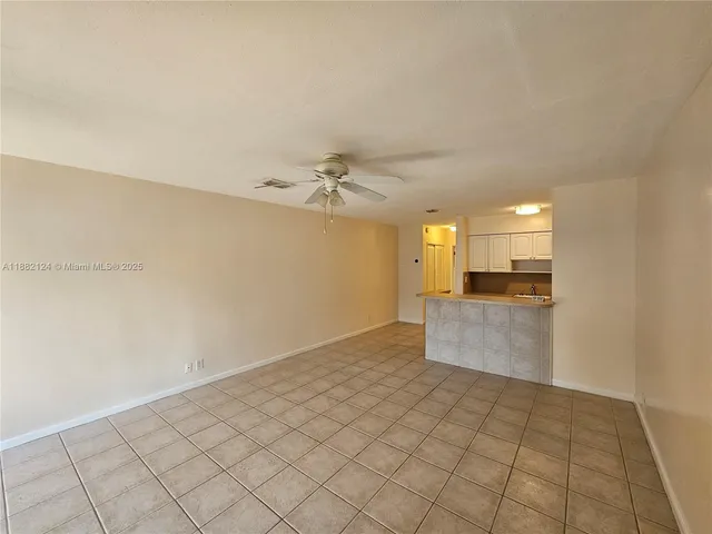 a view of a kitchen with a sink and cabinets