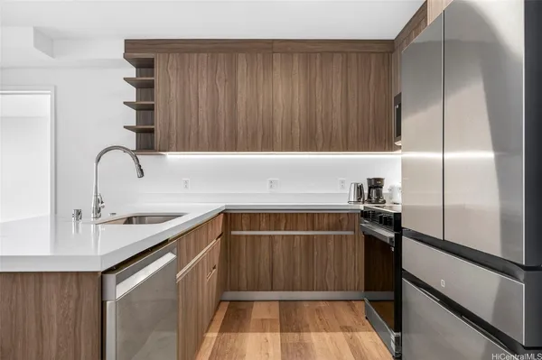 a kitchen with a sink appliances and cabinets