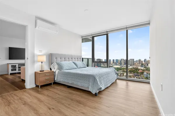 a bedroom with a large bed and a large window