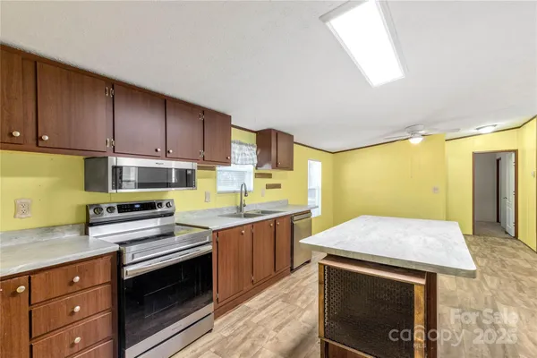a kitchen with a stove sink and cabinets