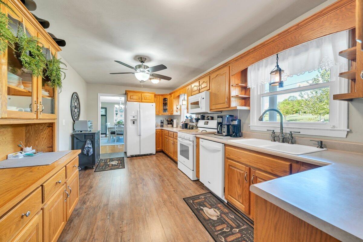 3226 Rakes Road Rocky Mount, VA 24151 - Photo 20 of 74 a large kitchen with stainless steel appliances a large window a sink and cabinets