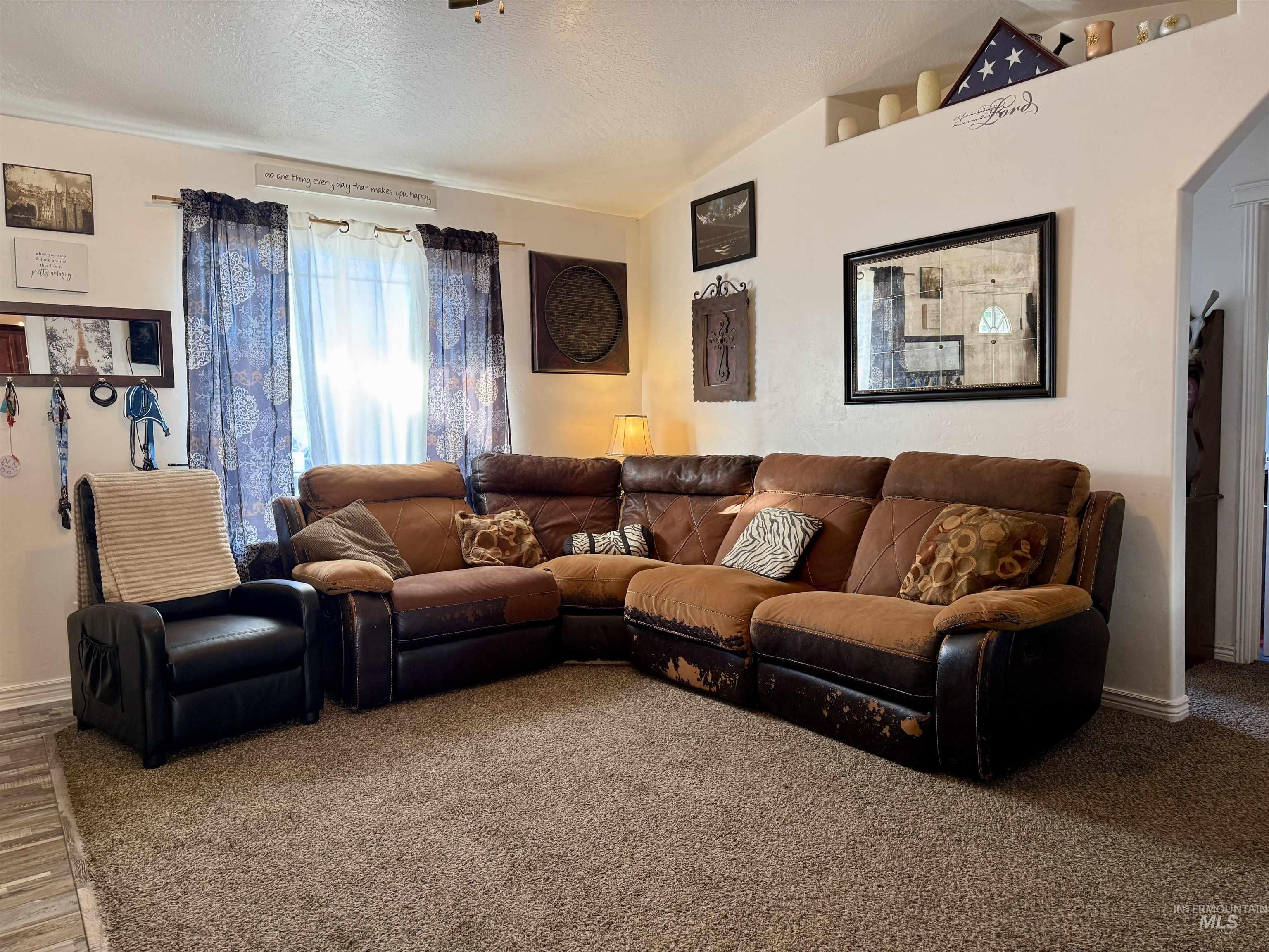 1141 Sunset Lane Kimberly, ID 83341 - Photo 3 of 6 Carpeted living room featuring baseboards and a textured ceiling