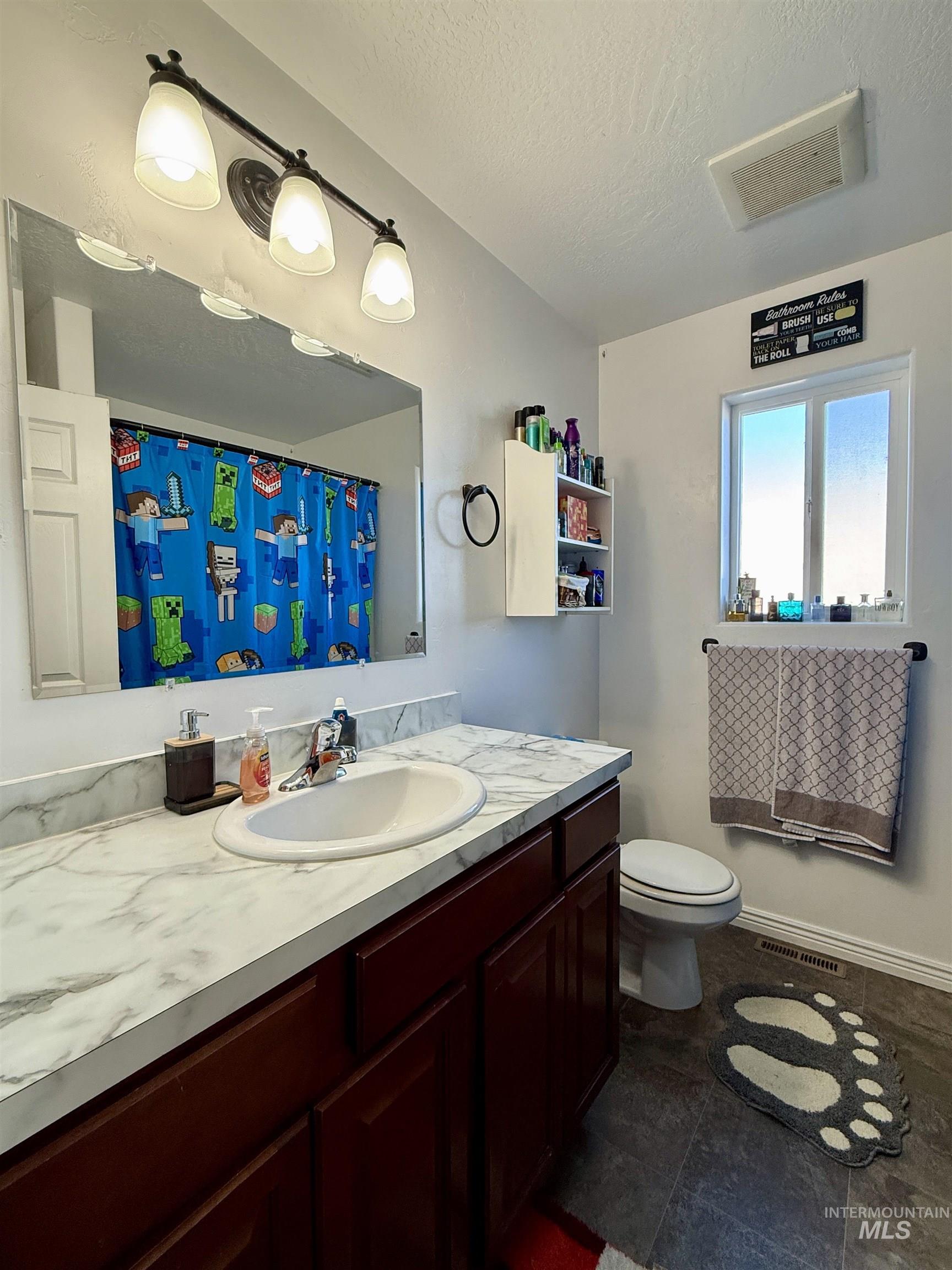 1141 Sunset Lane Kimberly, ID 83341 - Photo 6 of 6 Bathroom with vanity, a shower with curtain, and a textured ceiling