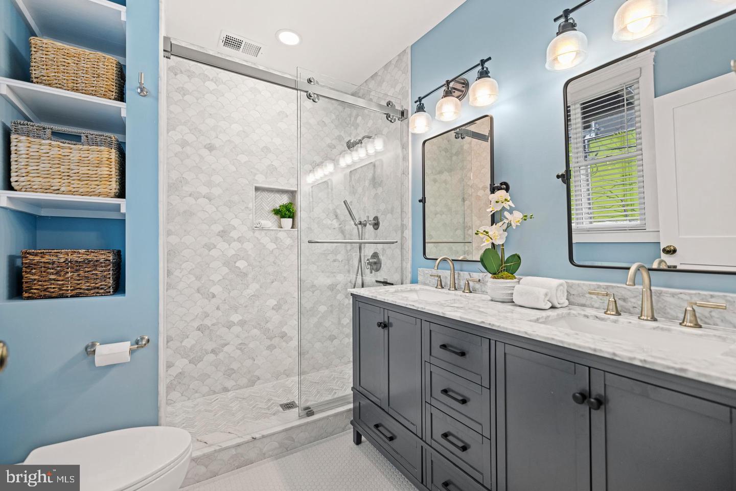 637 Allison Street Northwest Washington, DC 20011 - Photo 13 of 25 a bathroom with a granite countertop sink a mirror a shower and a toilet