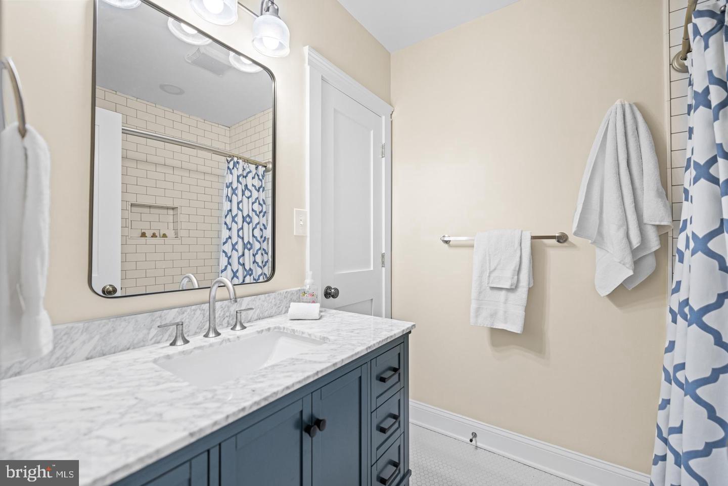 637 Allison Street Northwest Washington, DC 20011 - Photo 17 of 25 a bathroom with a granite countertop sink and a mirror