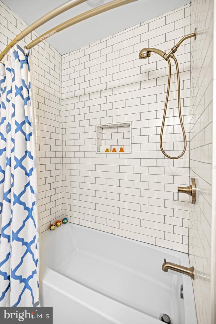 637 Allison Street Northwest Washington, DC 20011 - Photo 18 of 25 a bathroom with a shower and a bathtub