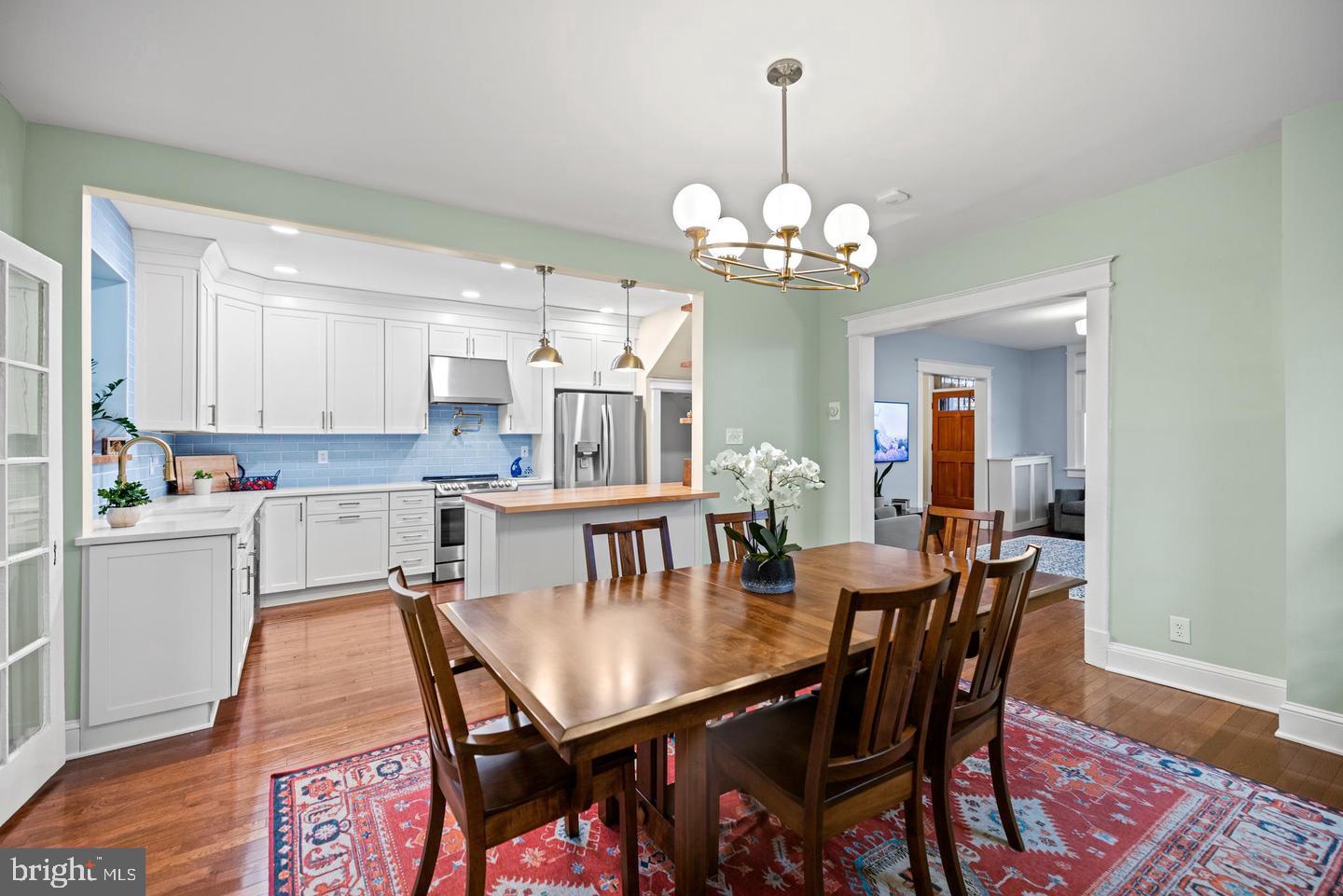 637 Allison Street Northwest Washington, DC 20011 - Photo 6 of 25 a view of a dining room with furniture wooden floor and chandelier