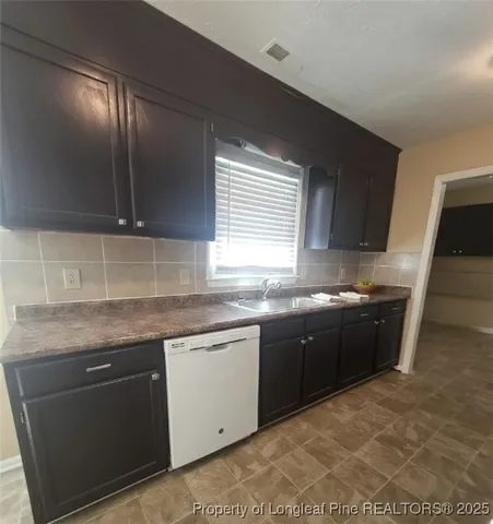 a kitchen with stainless steel appliances granite countertop a sink and stove
