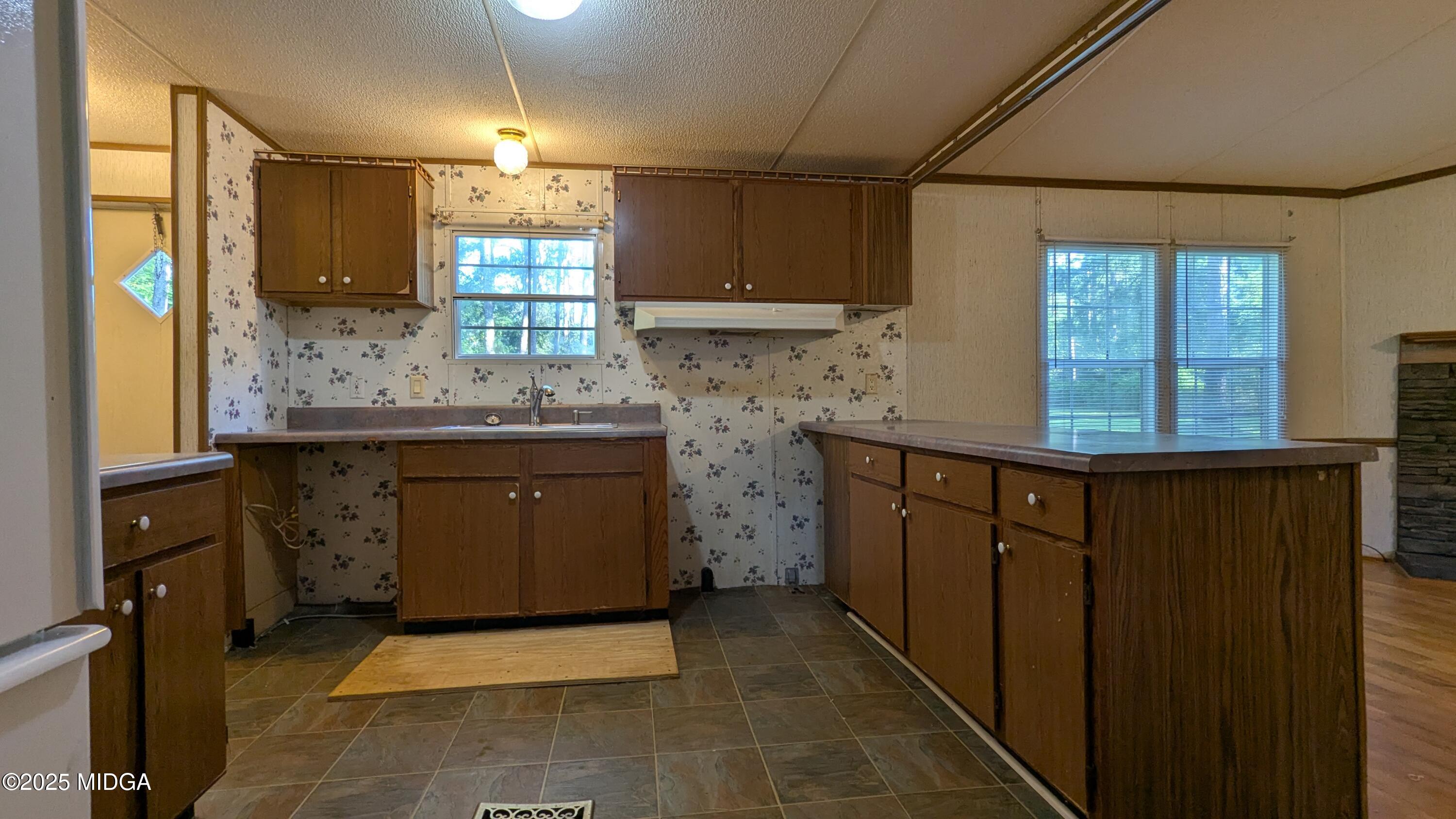 151 Hardy Road Gray, GA 31032 - Photo 14 of 18 a kitchen with a sink stove and cabinets