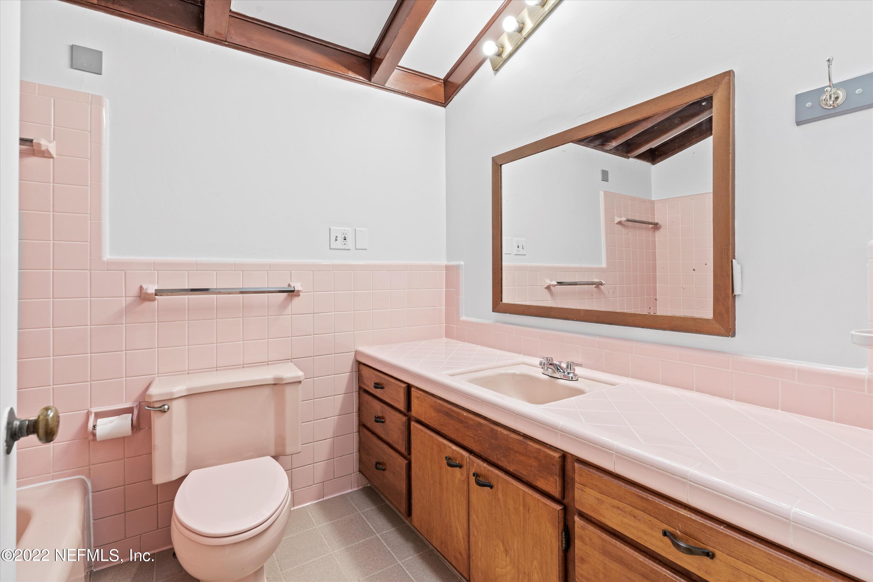 2452 Holly Point Road East Orange Park, FL 32073 - Photo 17 of 28 a bathroom with a toilet a sink and a mirror