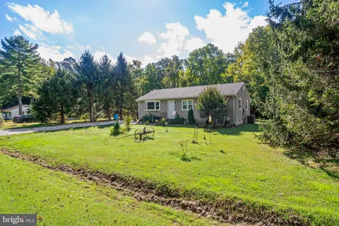 a swimming pool with outdoor seating and yard