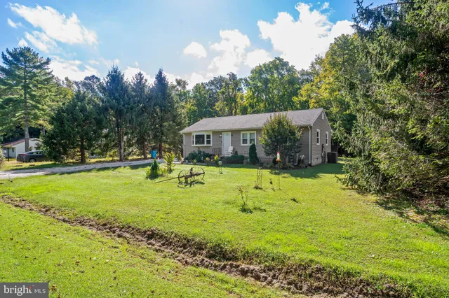 a swimming pool with outdoor seating and yard