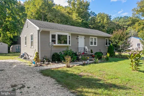 a view of a house with yard and sitting area
