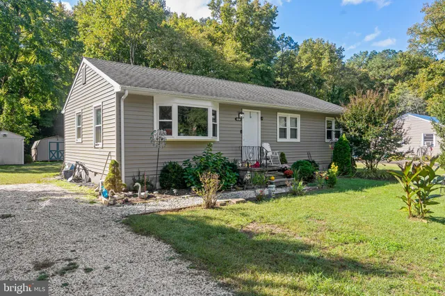a view of a house with yard and sitting area