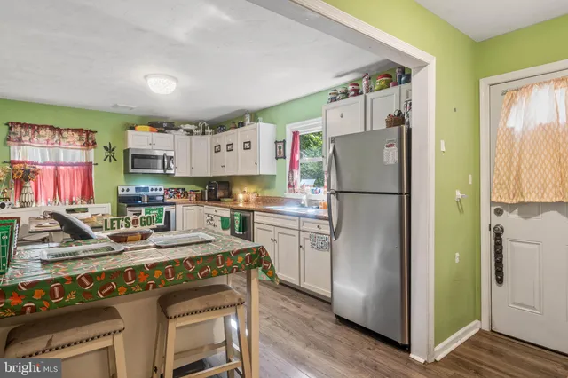 a kitchen with refrigerator and cabinets