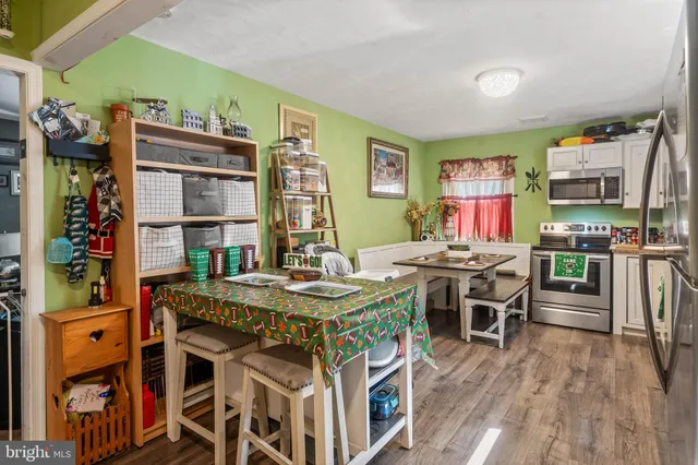 a view of a dining room with furniture and wooden floor