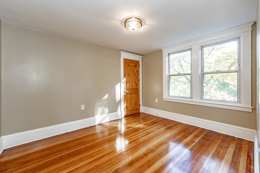 165 Laurelton Street Springfield, MA 01109 - Photo 17 of 31 a view of an empty room with wooden floor and a window