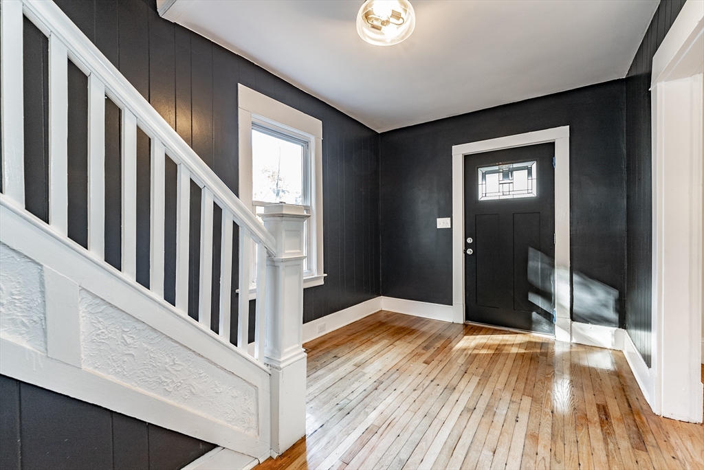 165 Laurelton Street Springfield, MA 01109 - Photo 4 of 31 a view of a hallway with wooden floor and staircase