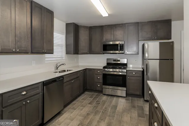 a kitchen with a refrigerator and a sink