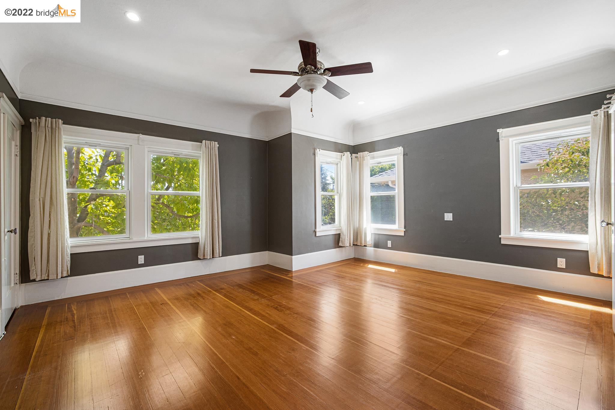 Undisclosed Address Berkeley, CA 94705 - Photo 11 of 28 a view of an empty room with a window and wooden floor